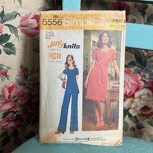 May include: Simplicity sewing pattern number 5556 for a dress and trousers. The pattern is for stretch knits and includes instructions for easy cut and easy sew. The pattern is for size 18, bust 40, and is for misses.