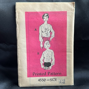 May include: A vintage sewing pattern packet with a pink background featuring illustrations of two blouses. The packet reads "Printed Pattern" and "4550 - SIZE 12". The illustrations show blouses with different necklines and sleeve styles.