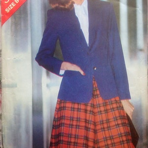 May include: A blue blazer with a white collared shirt and a red and black plaid skirt. The pattern on the skirt is a tartan plaid. The image includes the text "See & Sew 3285 SIZE B (14-16-18)".