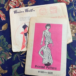 May include: Vintage sewing pattern envelope with a pink background and a black and white illustration of a woman wearing a jacket and a hat. The text on the envelope reads "Printed Pattern 9150 - SIZE 161/2".