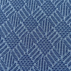 May include: Blue fabric with a white geometric pattern. The pattern is made up of small, repeating shapes that create a textured look.