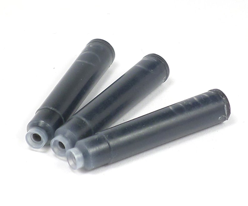 May include: Three black ink cartridges for fountain pens. The cartridges are made of plastic and have a clear plastic tip.