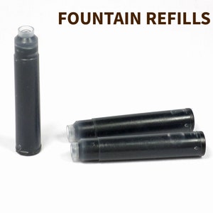 May include: Three black fountain pen ink cartridges with clear plastic ends. The text "FOUNTAIN REFILLS" is printed in brown at the top of the image.