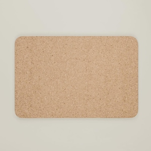 May include: A rectangular corkboard with rounded corners. The board has a natural, light brown color and a textured surface. The corkboard is designed for pinning notes, photos, or other items.