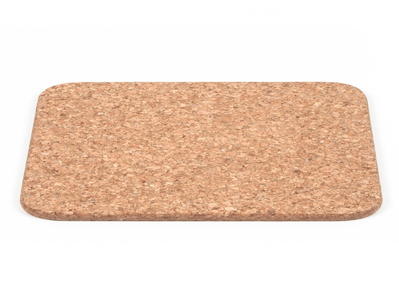 May include: A rectangular cork trivet with a light brown color and a slightly rounded edge.