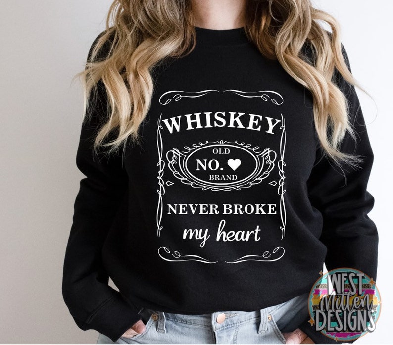 May include: Black sweatshirt with a white graphic design of a whiskey bottle label that says "Whiskey Old No. Brand Never Broke My Heart".