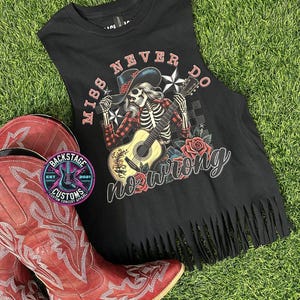 May include: Black sleeveless top with a fringed hem, displaying a skeleton playing a guitar, roses, and the words "Miss Never Do No Wrong." Red cowboy boots and a Backstage Customs logo are also visible.