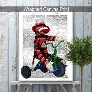 May include: A red and white striped monkey doll riding a green tricycle with blue wheels. The monkey is wearing a red and white striped hat and has a red nose. The tricycle has a basket on the front and a seat on the back. The background is a vintage book page with text.