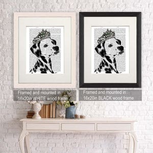May include: A black and white Dalmatian dog wearing a jeweled crown, printed on a vintage book page. The image is framed in a white wood frame and measures 16x20 inches.