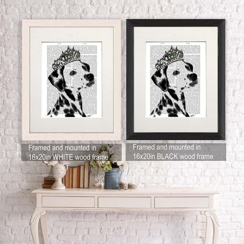 May include: A black and white Dalmatian dog wearing a jeweled crown, printed on a vintage book page. The image is framed in a white wood frame and measures 16x20 inches.