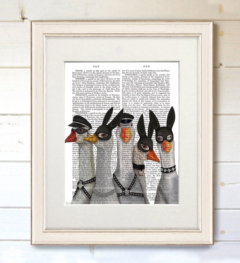 May include: Five geese wearing black and white masks and leather harnesses. The geese are standing in a row on a page of a vintage book. The text on the page is about the history of the town of Pen.