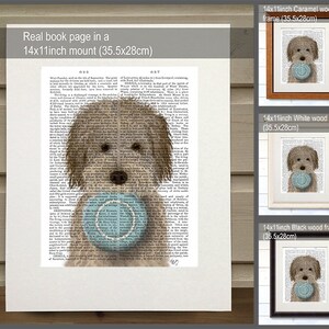 May include: A brown and white dog holding a blue ball, printed on a book page with text. The image is framed in three different colors: caramel, white, and black. Each frame is 14 inches by 11 inches (35.5 cm by 28 cm).