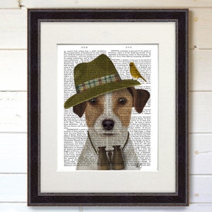May include: A brown and white dog wearing a green and brown hat with a plaid band and holding binoculars. The dog is looking at the camera. The background is a vintage book page with text.