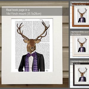 May include: A stag wearing a suit and bow tie, printed on a book page, framed in black, white, and caramel wood frames. The image is 14x11 inches and is mounted on a 14x11 inch mount.