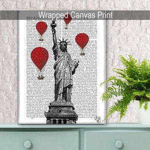 May include: A black and white illustration of the Statue of Liberty with red hot air balloons floating above her. The illustration is printed on a page of a vintage book.
