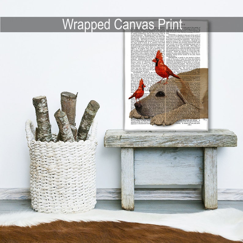 May include: A wrapped canvas print featuring a yellow Labrador Retriever with three red cardinals perched on its head. The background is a vintage book page with black text.