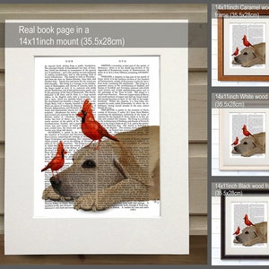 May include: A framed print of a dog with three red cardinals perched on its head. The print is set against a background of a vintage book page with text. The frame is available in caramel, white, and black wood.