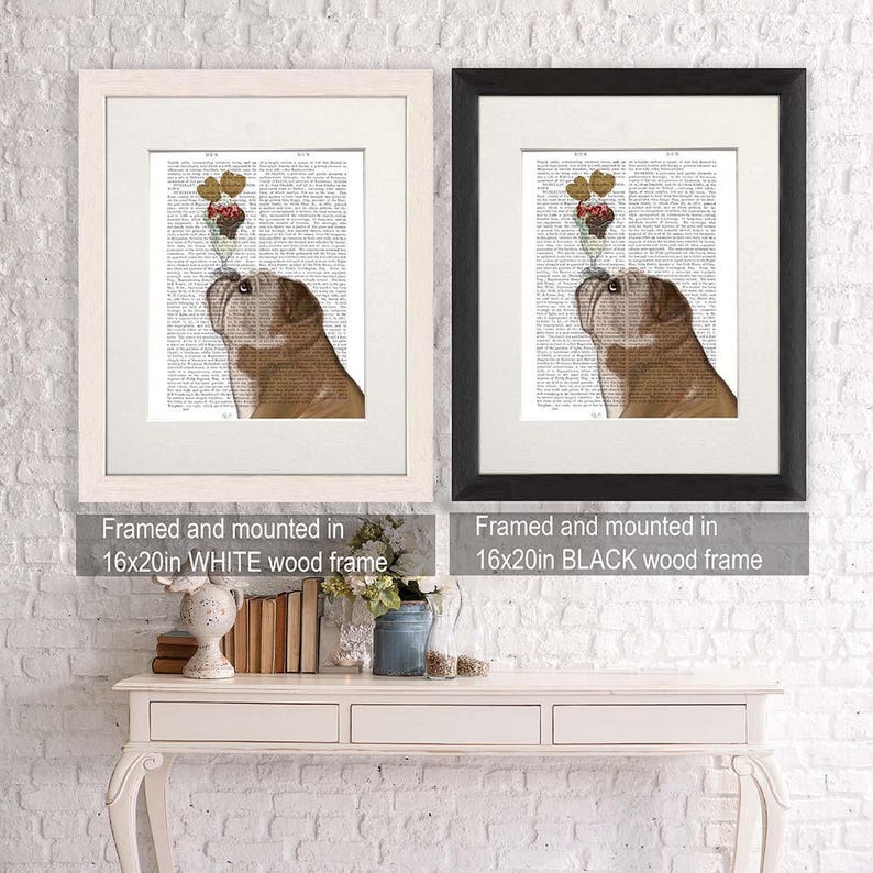 May include: A framed print featuring a brown bulldog looking up at a sundae. The artwork is set against a vintage book page background and framed in a 16x20 inch white wood frame. A second print is framed in a black wood frame.