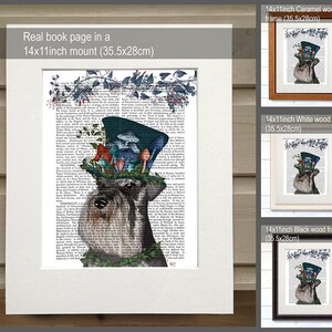 May include: A black and white illustration of a miniature schnauzer wearing a blue top hat with mushrooms and greenery. The image is printed on a book page and framed in a white wood frame. The frame is 14 inches by 11 inches and measures 35.5 cm by 28 cm.