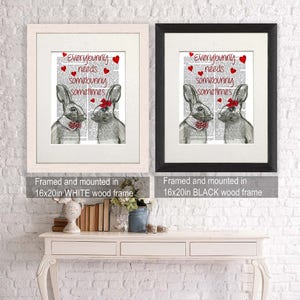 May include: Two framed prints of a black and white illustration of two bunnies with red bows. The text on the prints reads "Everybunny needs somebunny sometimes". The prints are framed in white and black wood frames. The frames are 16 inches by 20 inches.