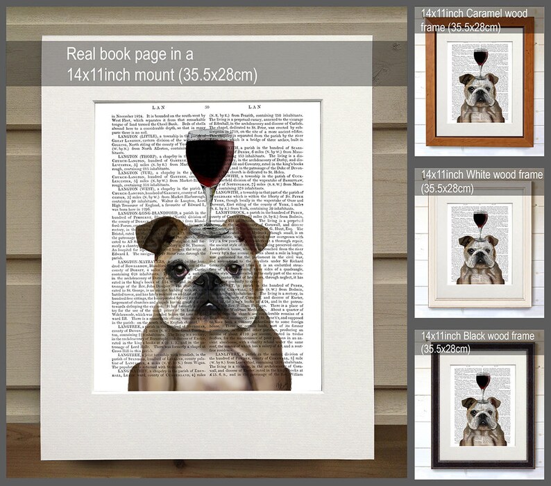 May include: A bulldog with a glass of red wine on its head, printed on a book page. The image is framed in a white, black, and caramel wood frame. The frame is 14 inches by 11 inches, or 35.5 centimeters by 28 centimeters.