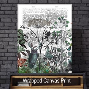 May include: A wrapped canvas print featuring a vintage owl illustration with a black and white background. The owl is surrounded by green and blue floral designs and text from an old book.