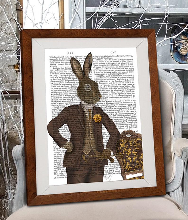 May include: A brown rabbit wearing a brown suit and a yellow flower boutonniere stands with one hand on his hip and the other holding a cane. He is standing in front of a brown and gold chair with a floral pattern. The background is a vintage book page with text.