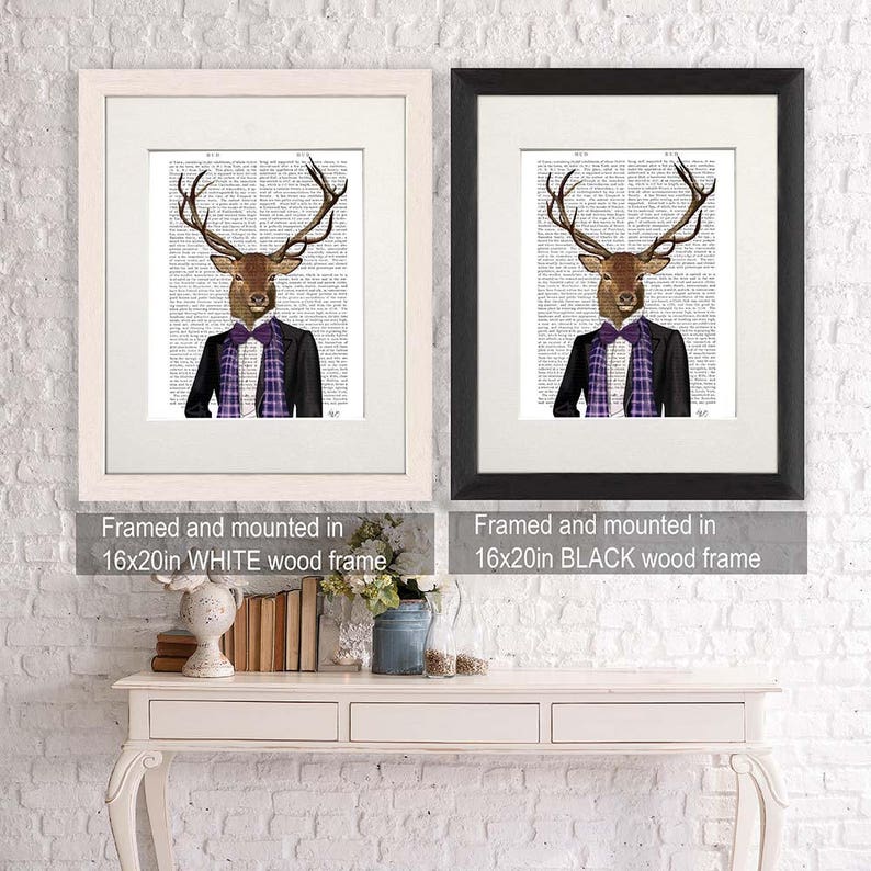 May include: Two framed prints of a deer wearing a suit and a purple and green plaid tie. The prints are framed in white and black wood frames. The text below the frames reads "Framed and mounted in 16x20in WHITE wood frame" and "Framed and mounted in 16x20in BLACK wood frame".