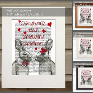 May include: A 14x11 inch print of a book page with a drawing of two bunnies with red bows. The text on the page reads "Everybunny needs somebunny sometimes". The print is shown in three different frames: caramel wood, white wood, and black wood.