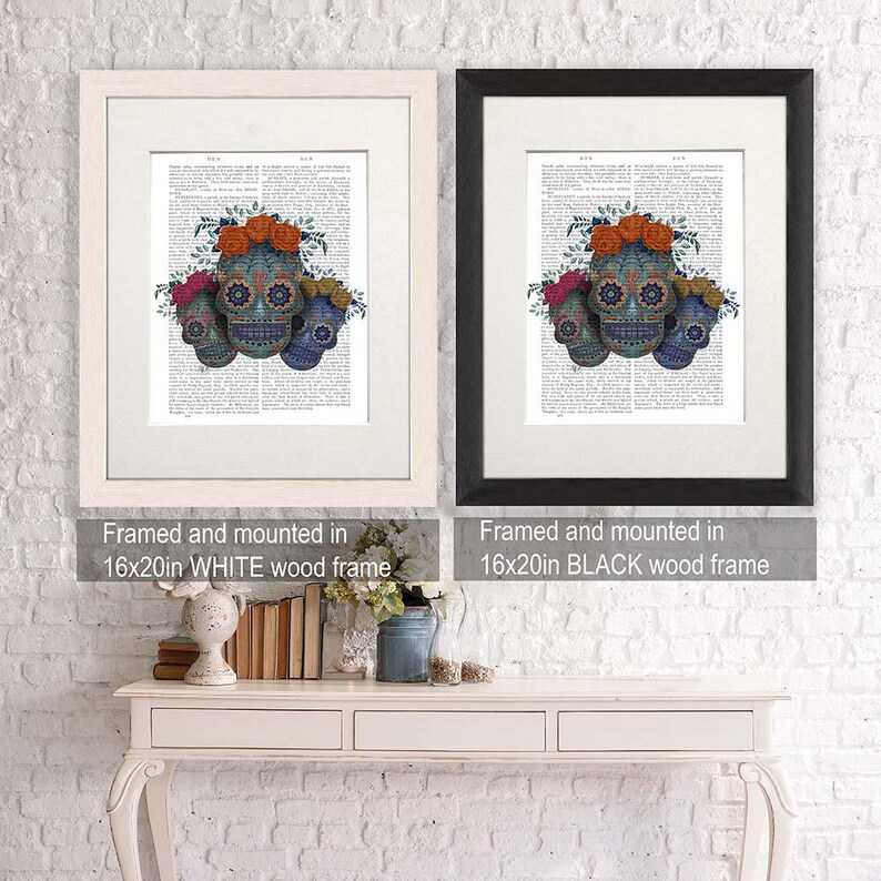 May include: Three sugar skulls with floral accents, framed in a white or black frame. The skulls are blue, orange, and pink with intricate designs. The frames are 16x20 inches.