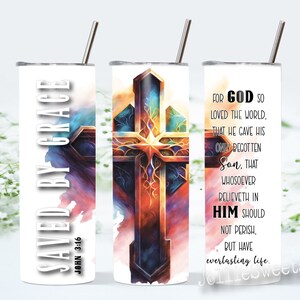 May include: A white tumbler with a colorful cross design and the text "Saved by Grace John 3:16" on one side and a bible verse about God's love on the other side.