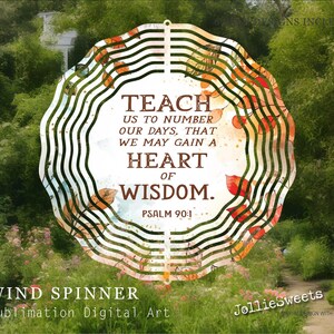 May include: A decorative wind spinner with a floral design and the text "Teach us to number our days, that we may gain a heart of wisdom. Psalm 90:1." The background features a garden scene.
