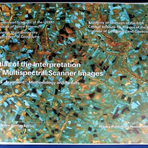 May include: A book cover with a colorful aerial photograph of a landscape. The title is "Atlas of the Interpretation of Multispectral Scanner Images" with the subtitle "MSS. Fragment" Methodology and Results. The book is published by Akademie Verlag Berlin and Nauka Publishing House Moscow.