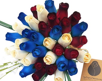 May include: A bouquet of wooden roses in cream, blue, and burgundy colors. The roses are arranged in a circular shape and tied together with twine. The text "The Original Wooden Roses Smiles for all occasions" is visible on a tag.