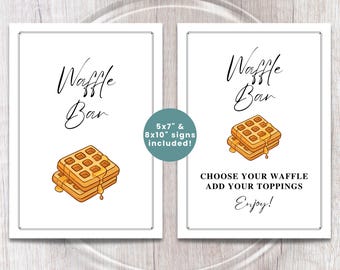May include: Two white signs with black text and illustrations. The left sign says "Waffle Bar" with a waffle illustration. The right sign says "Waffle Bar" with a waffle illustration and "Choose your waffle, add your toppings, Enjoy!"