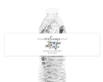 May include: White water bottle label with a floral design in shades of blue and white. The text on the label reads "welcome", "Elizabeth & Benjamin", and "03-09-2024".