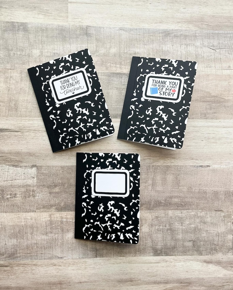 May include: Three composition notebooks with black and white speckled covers. Two notebooks have the text "THANK YOU FOR BEING MY TEACHER" and "THANK YOU FOR BEING A PART OF MY STORY" in white on a white label. The third notebook has a blank white label.