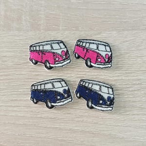 May include: Four embroidered iron-on patches of vintage Volkswagen vans. Two vans are pink with white trim and two vans are blue with white trim.