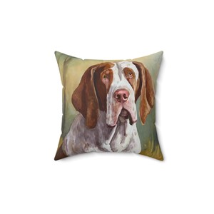 May include: Square throw pillow featuring a watercolor painting of a Bracco Italiano dog. The dog has a white and brown coat, with long, floppy ears and a pink nose. The background is a soft, muted green and yellow.