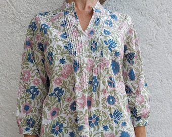 pop-over shirt in hand block printed cotton, floral fabric in shades of blue and pink, 3/4 sleeves, front pleats, mao collar, side slits