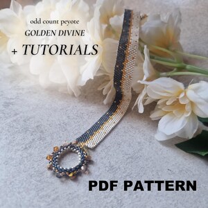 May include: A beaded bracelet with a circular clasp, featuring a pattern of gold, white, and dark blue beads. The bracelet is displayed on a surface with white flowers and the text "GOLDEN DIVINE + TUTORIALS PDF PATTERN".