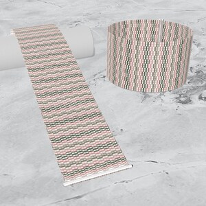 May include: A woven bracelet with a pink, green, and white geometric pattern. The bracelet is shown flat and rolled up.