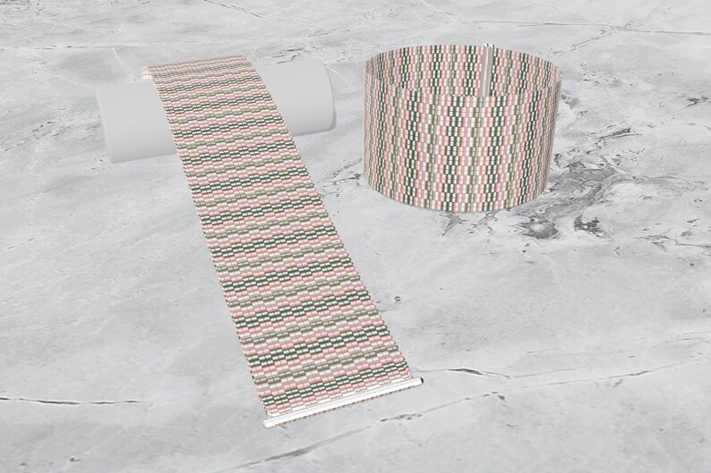 May include: A woven bracelet with a pink, green, and white geometric pattern. The bracelet is shown flat and rolled up.