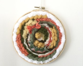 Circular wall weaving in pure wool and wool blend mounted on wooden embroidery hoop