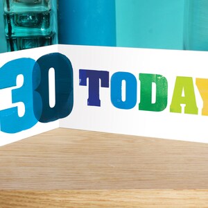 May include: A white card with the text "You are 30 TODAY!" in colourful letters. The number 30 is in blue and partially overlaps the text.
