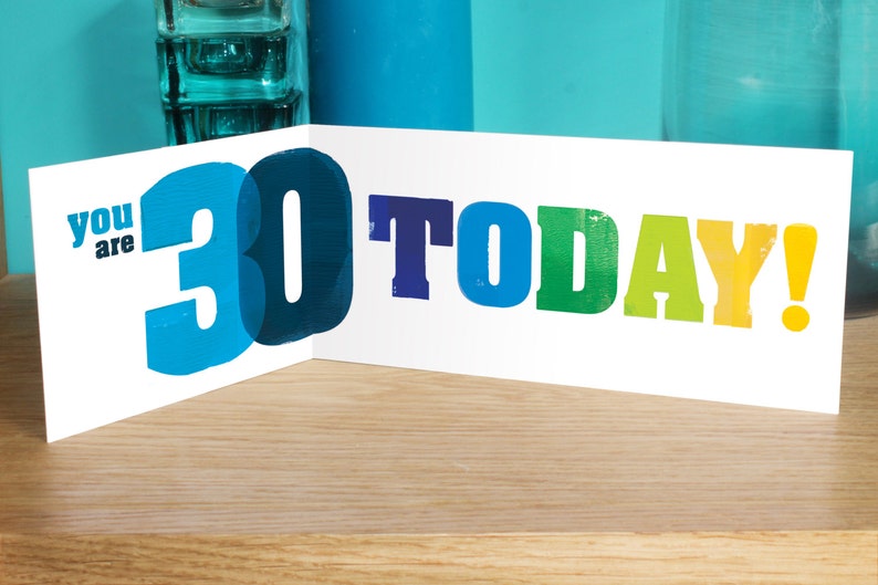 May include: A white card with the text "You are 30 TODAY!" in colourful letters. The number 30 is in blue and partially overlaps the text.