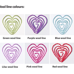 May include: Six heart shapes made of wool yarn in different colors: green, purple, blue, lilac, pink, and red. Each heart is made of multiple layers of yarn, creating a layered effect.
