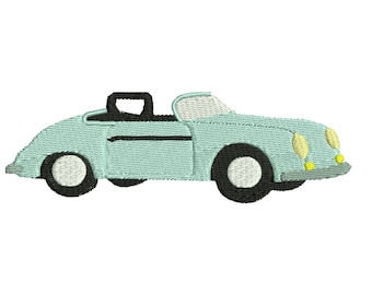 May include: A light blue convertible car with black trim and yellow headlights. The car is a vintage style.