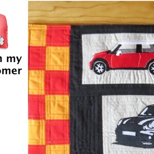 May include: A red and black quilted fabric wall hanging with a checkered pattern and two embroidered images of Mini Cooper cars. The text "From my Customer" is visible in the upper left corner.
