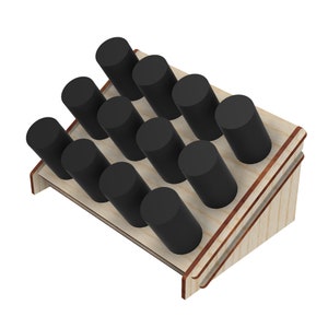 May include: Wooden display stand with 10 slots for holding round black bottles or tubes. The stand is made of light wood with a brown stain and has a slanted design.